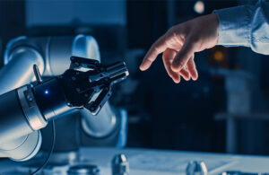 robot gripper touches the finger of a human hand.