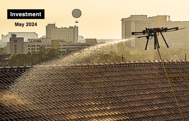 an aerial drone spraying liquid onto a roof