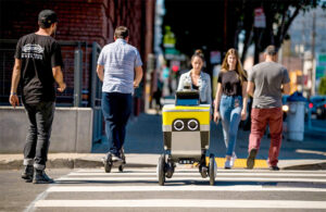 a Serve mobile robot crosses the street on a crosswalk.