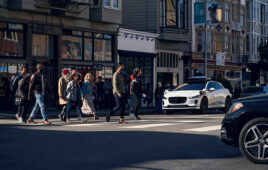 A Waymo vehicle pulling up to a crosswalk in San Francisco.